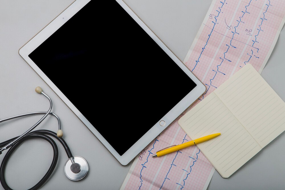 Cardiogram and tablet with notepad
